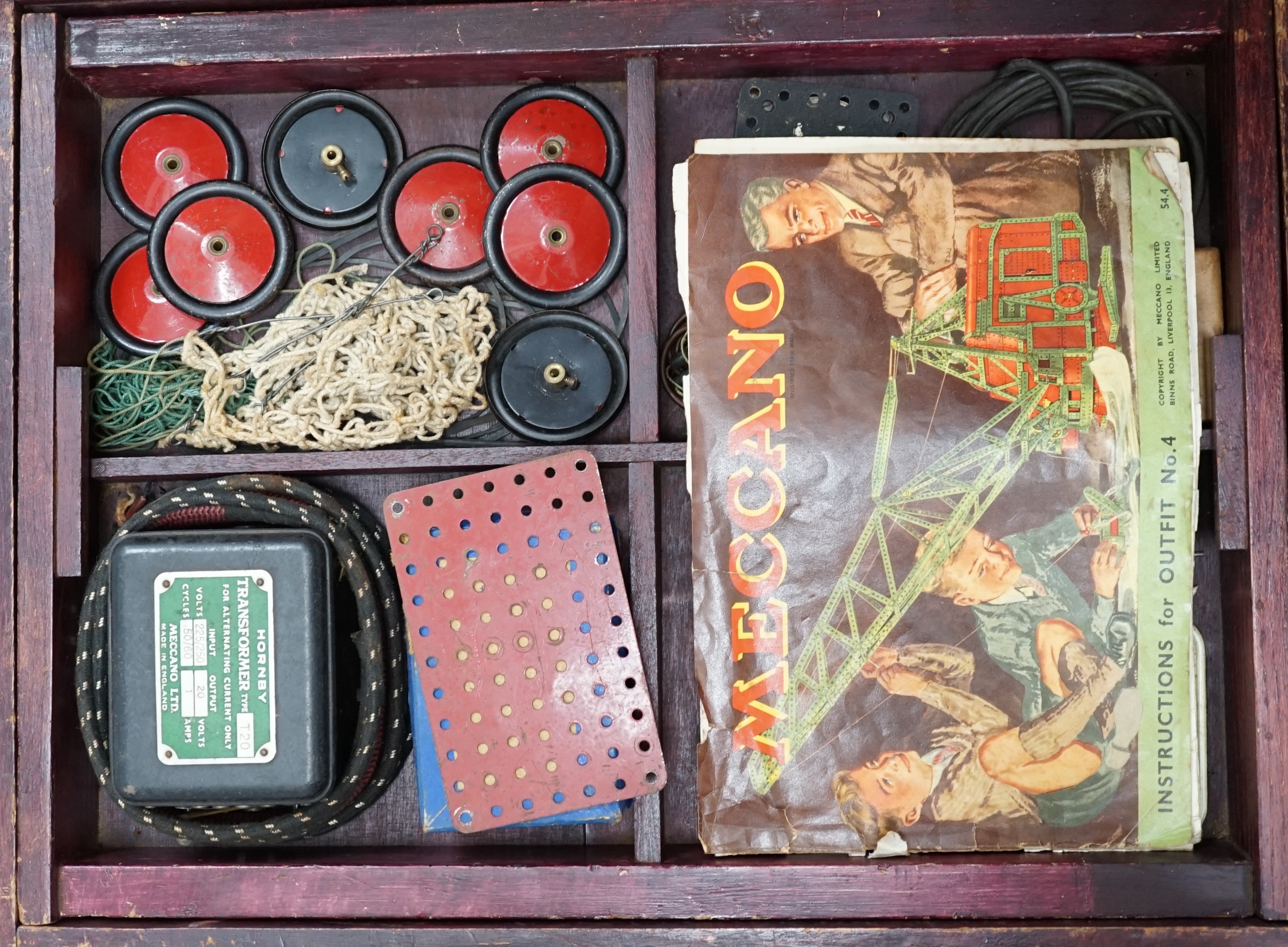 A collection of early Meccano components, mainly from the red and green period, comprising of some of the more unusual wheels and circular parts, some instruction books, etc. well organised into two wooden boxes